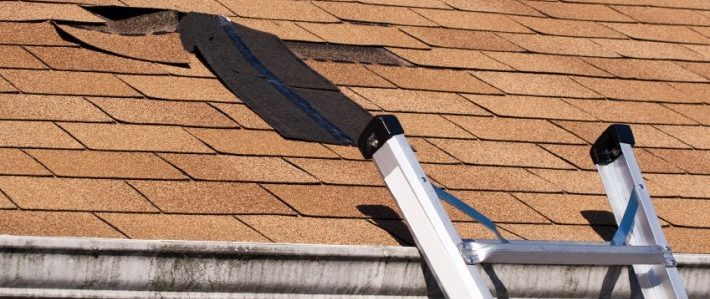 ladder leading to a damaged roof