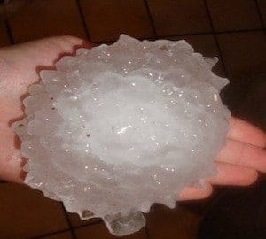 person holding hail stone as large as their hand